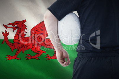 Composite image of rugby player holding a rugby ball