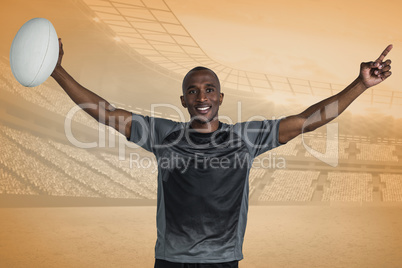 Composite image of confident sportsman with arms raised holding