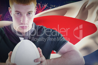 Composite image of rugby player holding a rugby ball