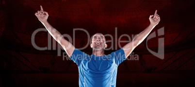 Composite image of happy rugby player with arms raised