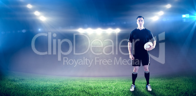 Composite image of rugby player holding a rugby ball