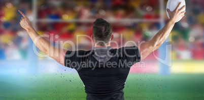 Composite image of rugby player celebrating with the ball