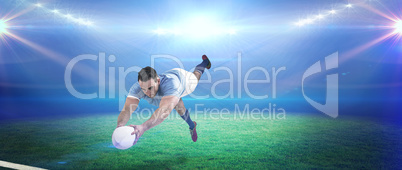 Composite image of rugby player scoring a try