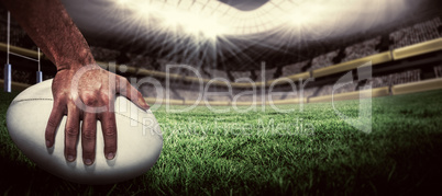 Composite image of close-up of sports player holding ball