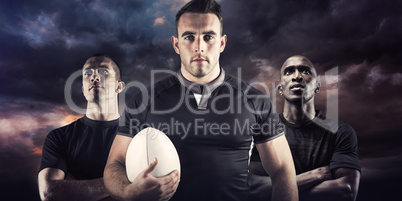 Composite image of tough rugby player holding ball