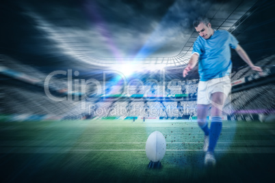 Composite image of rugby player doing a drop kick