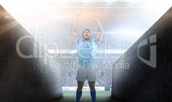 Composite image of rugby player cheering and pointing