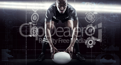 Composite image of sportsman holding ball while playing rugby Composite image of sportsman holding ball while playing rugby