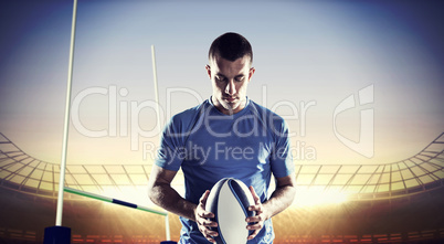 Composite image of rugby player holding ball