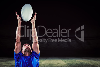 Composite image of rugby player catching ball