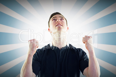 Composite image of excited rugby player gesturing victory