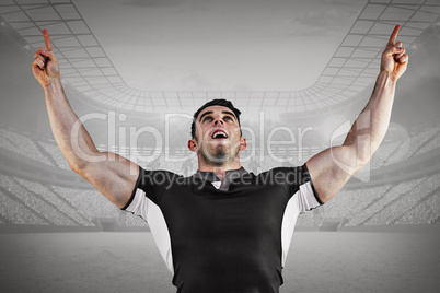 Composite image of rugby player cheering and pointing