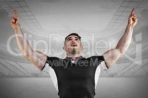 Composite image of rugby player cheering and pointing