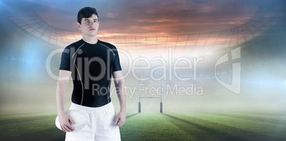 Composite image of rugby player holding a rugby ball