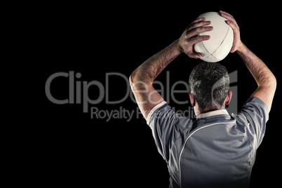 Composite image of rugby player about to throw a rugby ball