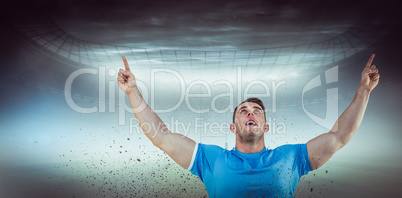 Composite image of rugby player cheering and pointing