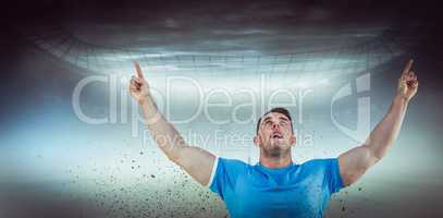 Composite image of rugby player cheering and pointing