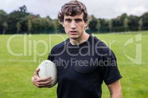 Rugby player scowling at camera