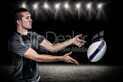 Composite image of rugby player catching ball