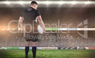 Composite image of tough rugby player holding ball