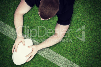 Composite image of a rugby player scoring a try