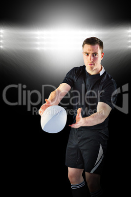 Composite image of rugby player about to throw a rugby ball