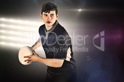 Composite image of rugby player about to throw a rugby ball