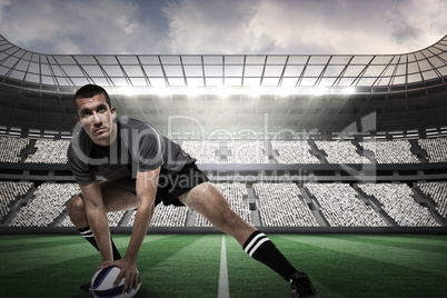 Composite image of sports player in black jersey stretching with