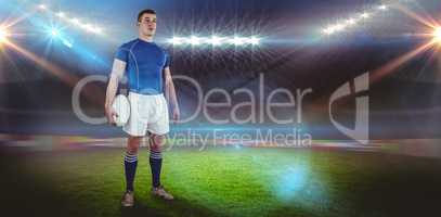 Composite image of rugby player holding a rugby ball