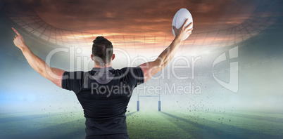 Composite image of rugby player celebrating with the ball