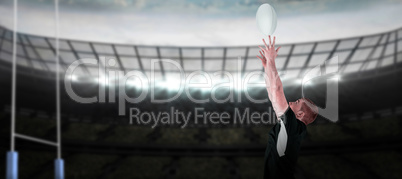 Composite image of rugby player catching a rugby ball