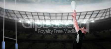 Composite image of rugby player catching a rugby ball