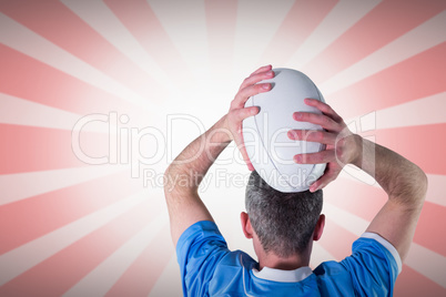 Composite image of rugby player about to throw a rugby ball