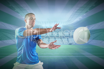 Composite image of rugby player catching the ball