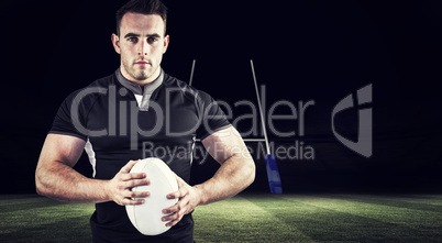 Composite image of tough rugby player looking at camera