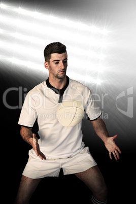 Composite image of rugby player taking position