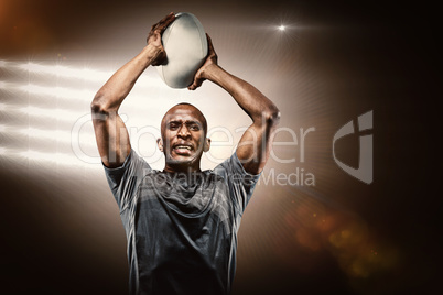 Composite image of determined sportsman throwing rugby ball Composite image of determined sportsman throwing rugby ball
