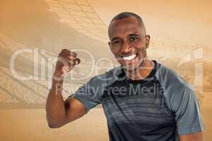 Composite image of portrait of sportsman cheering after success