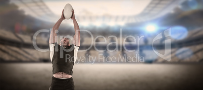 Composite image of rugby player catching the ball