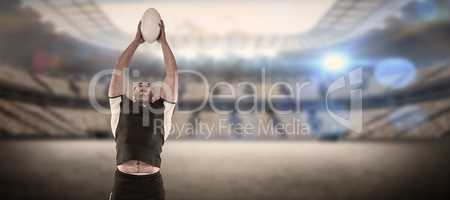 Composite image of rugby player catching the ball