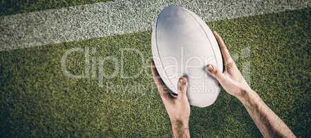 Composite image of a rugby player posing a rugby ball