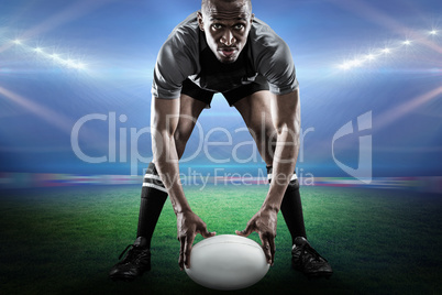 Composite image of sportsman holding ball while playing rugby