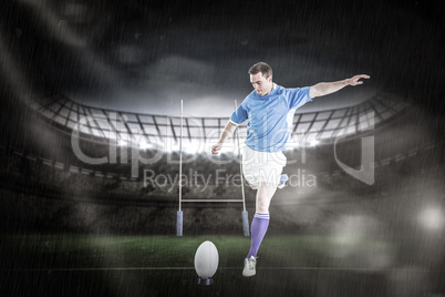 Composite image of rugby player doing a drop kick