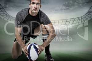 Composite image of portrait of rugby player in black jersey plac