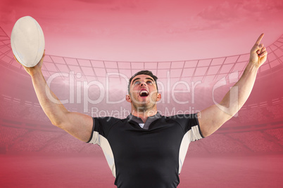 Composite image of rugby player cheering with the ball