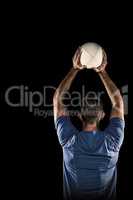 Composite image of rear view of sports player throwing ball