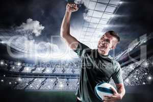 Composite image of cheerful rugby player punching the air