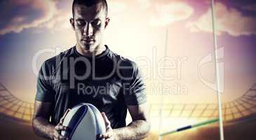 Composite image of thoughtful rugby player holding ball