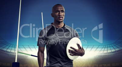 Composite image of thoughtful athlete holding rugby ball
