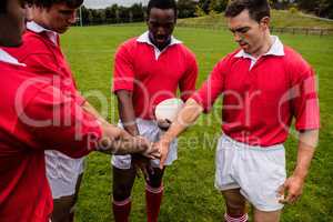 Rugby players putting hands together